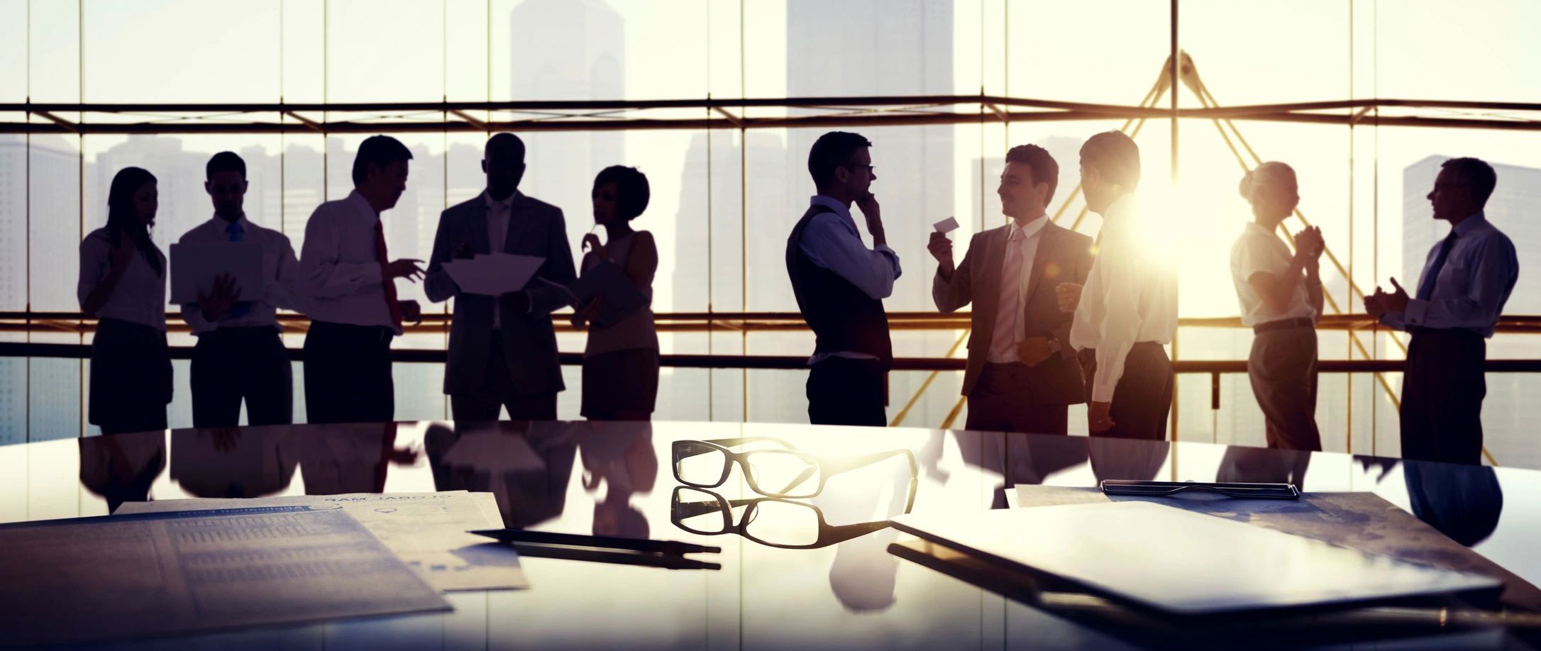 A group of people standing around a table.